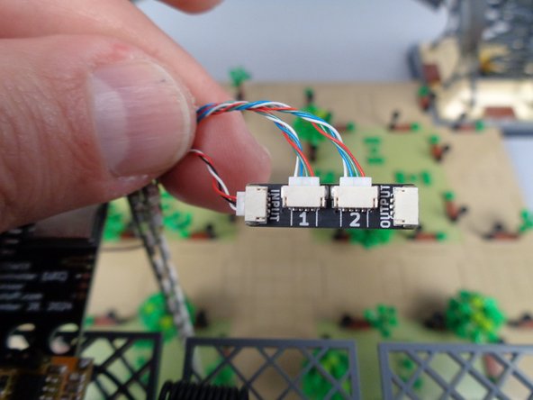 The first photo for this step shows how the connections to your first adapter board should look, with the cable connected to the INPUT plug on the adapter running back to the main controller.