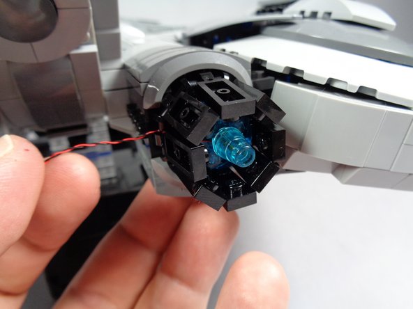 As shown in the second photo, carefully re-attach both engines to their axles.