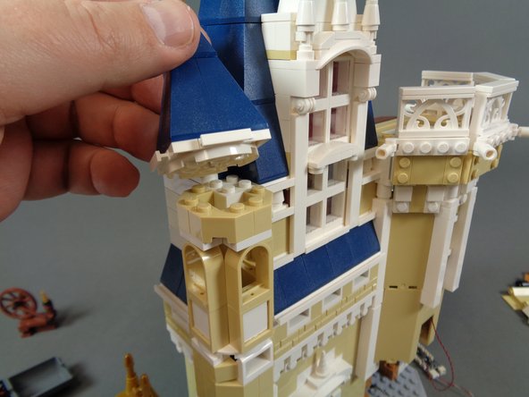 As shown in the photos for this step, remove the small tower top from the turret next to the bedroom and mount the second warm white Pico LED light in the center of the round white LEGO plate.