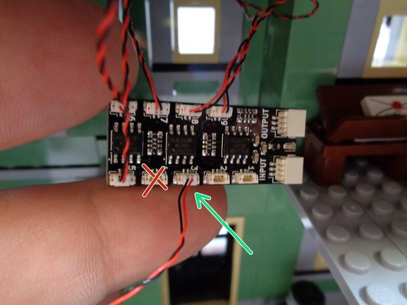 As shown by the green arrow in the photo for this step. connect the yellow front porch light to plug #3 on the BRANCH09X adapter board.