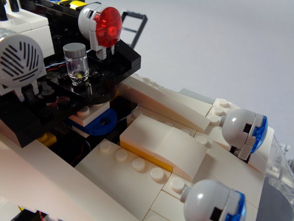 Carefully turn the rear roof section right-side up again and place it on top of the vehicle.  Do not re-attach the roof yet.