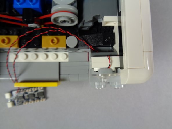 The second and third photos for this step show how your setup should look after re-attaching the first headlight assembly.