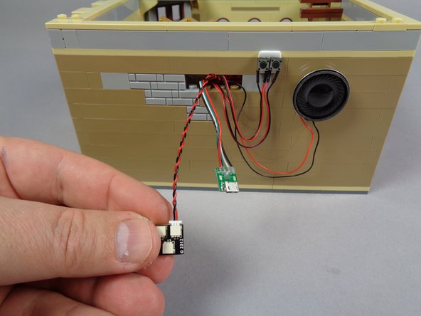 The two photos in this step show two different approaches for powering the video player: