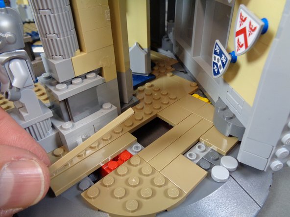 As shown in the first and second photos for this step, re-attach the two long dark tan tiles you removed in the last step so they leave a gap in the floor.