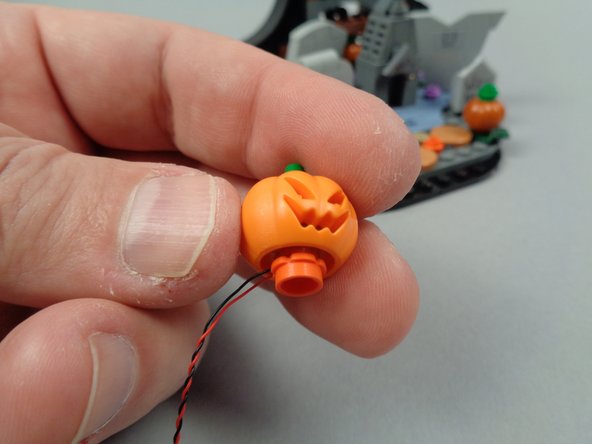 As shown in the first photo for this step, re-attach the pumpkin to its flower base.