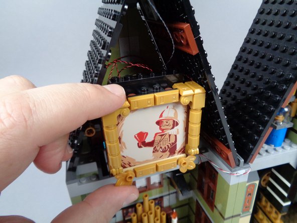 Note that the BRANCH06X adapter board can hang freely behind the painting-- it does not need to be attached to any LEGO element.  Just make sure the LED light wires are coiled up behind the painting so no excess wire is visible after the painting is put back into place.