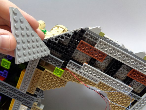 Make sure the four flame wires pass BETWEEN studs under the lime green plate, not over them.  If wires become pinched by a stud, they can become damaged and the lights may stop working.