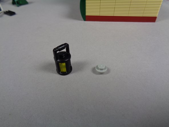 As shown in the first photo, remove the light bluish gray 1x1 round plate from the bottom of the lantern.