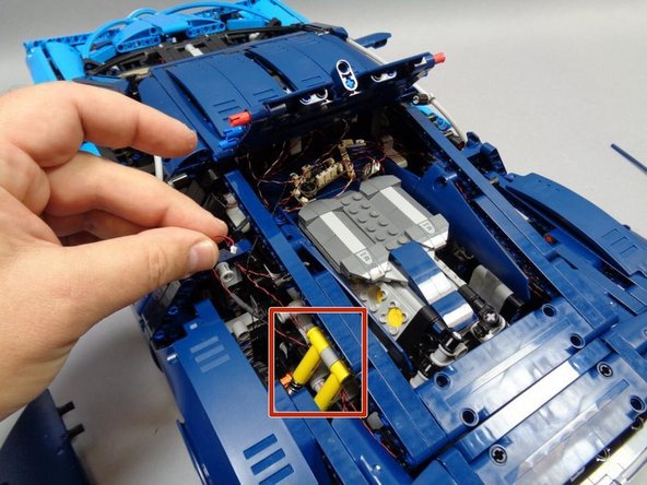 Route the wires as shown in the second photo, making sure the wires go behind the yellow shock absorbers as shown by the red square.