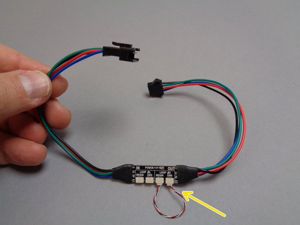 The third photo shows the inter-level connecting board.  This board has large plugs on both ends, which are used to connect lights between different levels in your Eiffel Tower.