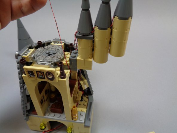 As shown in the second and third photos, route the light wire through the same gap in the floor as the three rooftop tower lights.