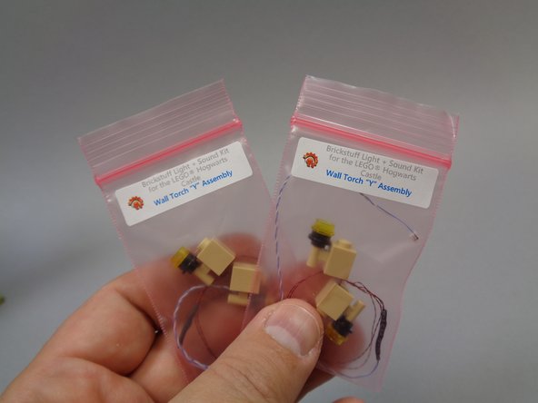 You should have two small pink bags inside the larger Bag 9, each labeled &quot;Wall Torch 'Y' Assembly&quot;.  Remove these, and carefully unpack the torch assemblies inside.  Un-tangle any wires that may be tangled, being careful not to pull on the torches.