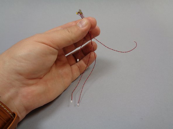 Using the two transparent &quot;boat stud&quot; parts included in Bag 6, attach one light with 6&quot; cable and one light with 3&quot; cable to the ceiling in the main hall as shown in the third photo.