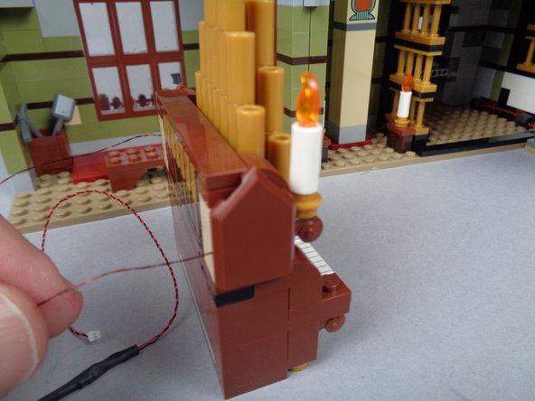 As shown in the third photo for this step, place the organ back in the front room.