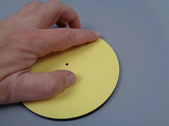 The red arrows in the first photo for this step show the LEGO printing on the back side of the paper moon.  Align this printing with the bottom of your frame, and carefully run your fingers around the outside of the frame to snap the paper into the frame on top of the light strip.