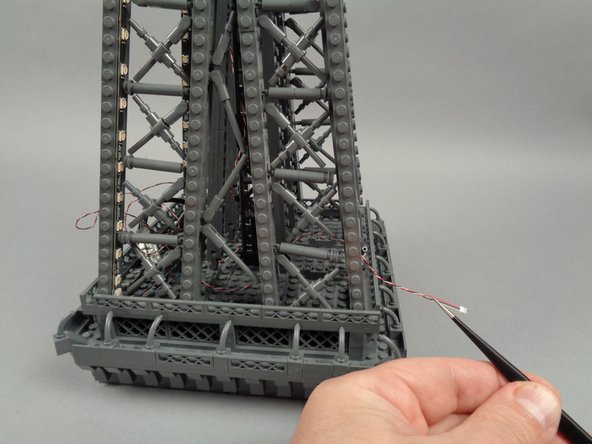 As shown in the third photo for this step, pull the end of the control cable through the next pillar.  This will make it easier to connect the next adapter board.