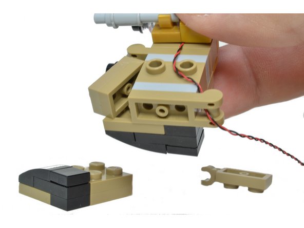 Carefully thread the wire through the hole in the clip on the robot's bottom part in back.