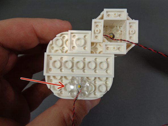 As shown by the red arrow in the first photo, use a second &quot;boat stud&quot; piece to secure the second ceiling light.  Make sure to position the light exactly as shown in the photo.