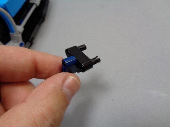 As shown in these three photos, remove the center mount from the roof beam, and then feed the cable of the cool white Pico LED through the Technic pin hole.