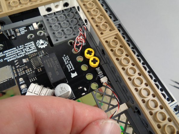 As shown by the green circle in the second photo for this step, connect the end of the control cable to the plug labeled "LOOP END" on the main controller.