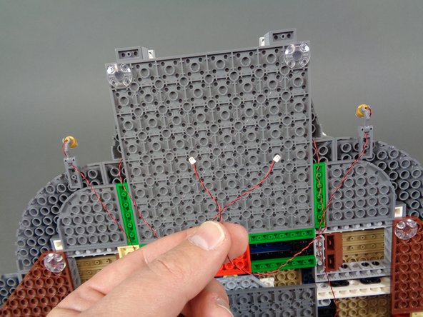 As shown in the photos for this step, connect the wires from the two front door torches to plugs 5 and 6 on the BRANCH09XS adapter board.