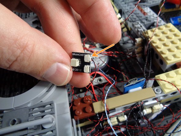 Take the BRANCH03 adapter board you used at the beginning of installation to identify the internal lights, and connect the hyperdrive light wire to one of the small plugs on the BRANCH03 adapter as shown by the orange arrow in the second photo.
