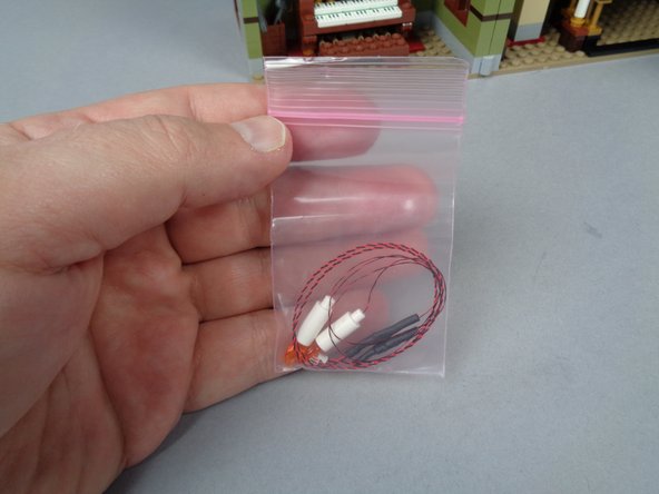 As shown in the first photo for this step, inside your BOX #3, there will be two pre-lit candles in a small pink bag.