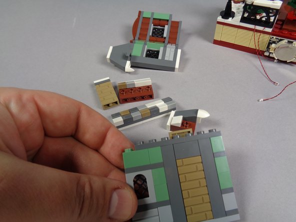 As shown in the first photo, separate the main wall section from its frame and remove the chimney and show/roof pieces from the back side.