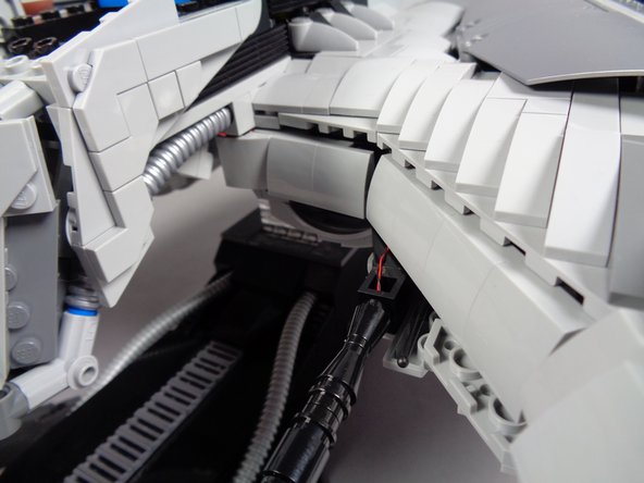 The third photo shows what your gun setup should look like once mounted and once the light wires have been hidden behind the armor sections.