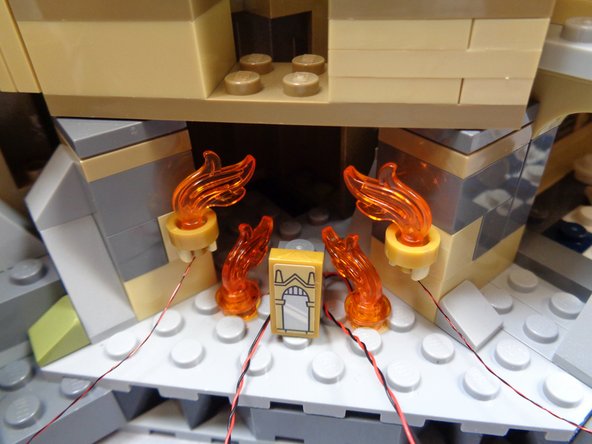 Carefully replace the round plate and modified flame part on top of each warm white light as shown in the second photo.