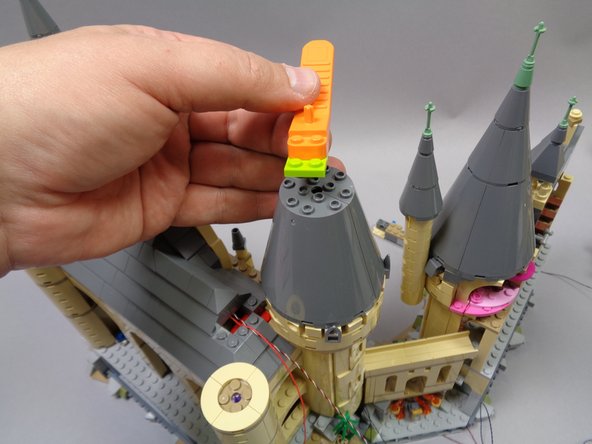 Now you will repeat the same steps you used on the first tower to add three warm white window lights to the second tower.  Begin by disassembling the top of the tower as shown in the photos.