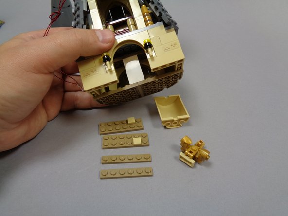 As shown in photo, remove pieces from the bottom of the top tower section.