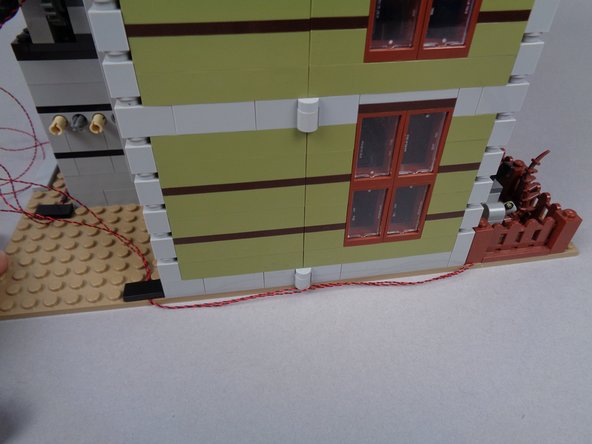 As shown in the photos for this step, test opening and closing the halves of the mansion to make sure there is enough &quot;play&quot; in the light wires to allow the house to fully open and close without pinching or pulling any wires.