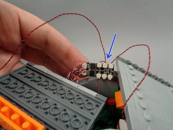 As shown by the arrow in the first photo for this step, connect the second green roof light to the last open plug on the BRANCH06X driver board (plug #2).