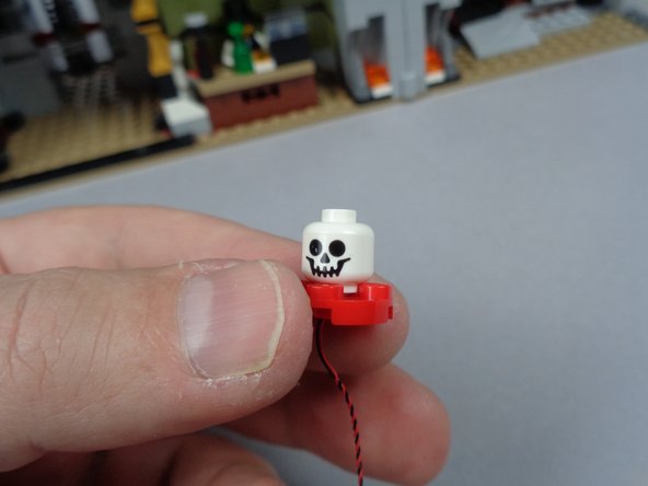 As shown in the photos for this step, re-assemble the skull jar parts and place the jar back in its spot in the attic.