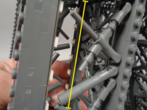 As shown in the second photo for this step, attach the second light strip (shown by the yellow line) and make sure it is firmly attached to the pillar.