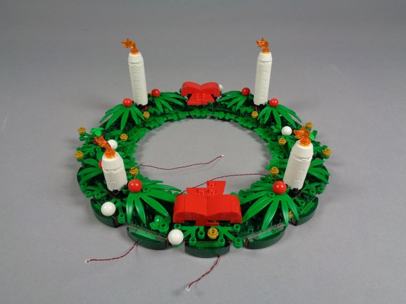 As shown in the first photo, re-attach the two candles with short wires.