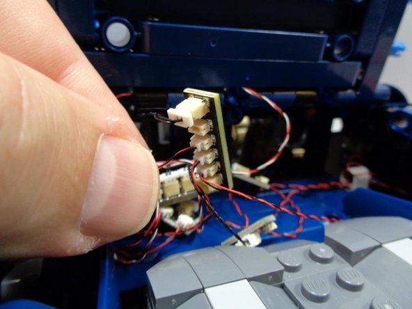 As shown in the third photo, connect the spoiler LED cable to one of the available small connecting plugs on the BRANCH15 adapter.