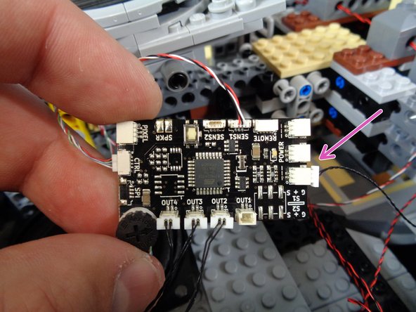 As shown in the first photo, the large white plug can be fed down through the Falcon frame toward the TRUNK08 master controller.