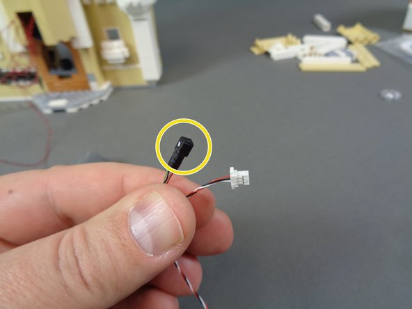 Inside your &quot;Middle Level Lights and Parts&quot; bag should be one last wire; this one will have a large white plug on one end and a small black connector without pins on the other end.