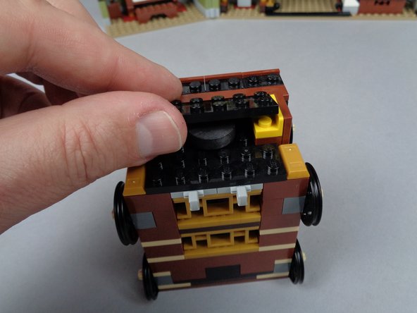 As shown in the photos for this step, re-assemble the elevator by replacing the two parts you removed earlier.