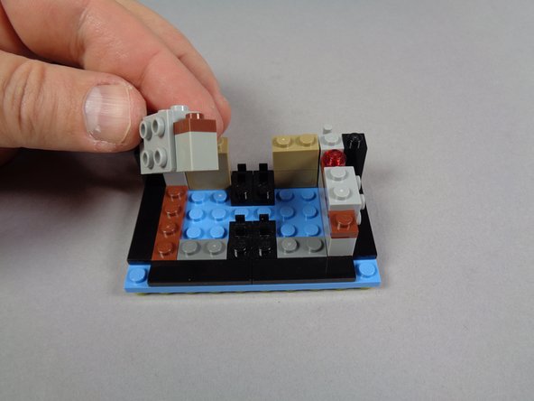 As shown in the photos for this step, continue disassembling the marquee bottom by removing the front and side inner sections.