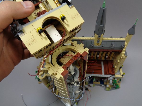 As shown in the second photo, bring the tower top section close to the lower section.  You will need to keep the two sections close together while you connect the light wires.