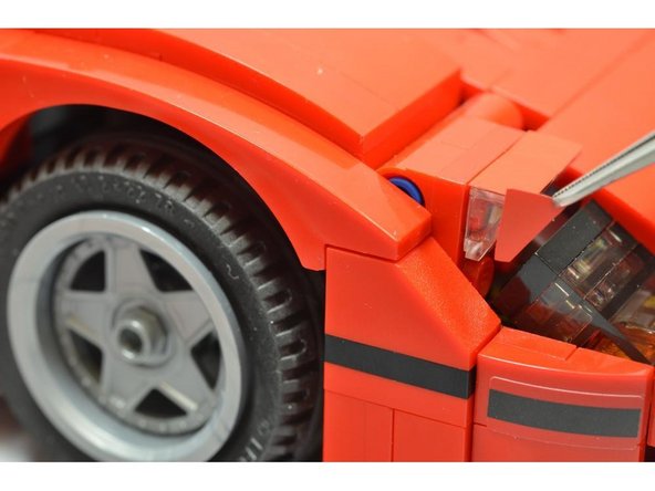 Carefully remove the triangle (side) stickers and apply them to both sides of each headlight as shown.