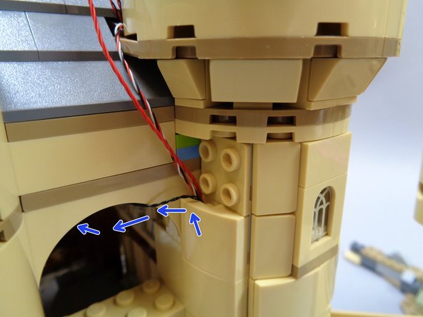 Now you can attach the remaining tan slopes to cover the wires all the way up to the top of the tower.