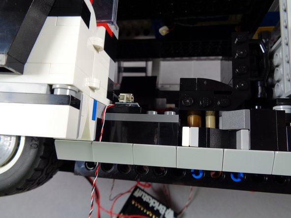 Replace the light bluish gray slope, again making sure the wire is not pinched on top of any studs.