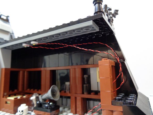 As shown in the first photo, mount the warm white Pico LED light on the attic ceiling next to the orange light you mounted earlier.  Run the wires for the warm white light along the same path as the orange light wires.