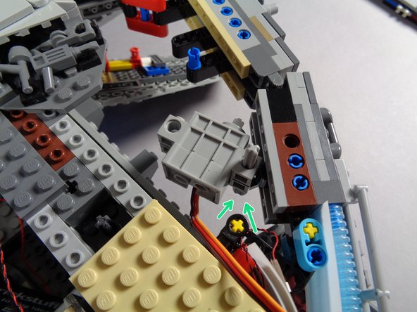 As shown in the first photo, pass the axle through the hole in the side of the servo.