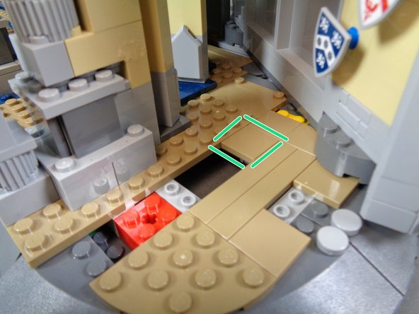 As shown in the second and third photos, take the 2x2 tile you removed in the previous step and attach it to the top of the open space created by removing the two long tiles as shown by the green square in the third photo.