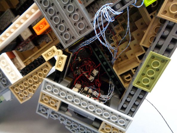 As shown in the third photo, tuck all remaining wires along with the second BRANCH09X adapter board up into the same space as the first BRNACH09X adapter board.